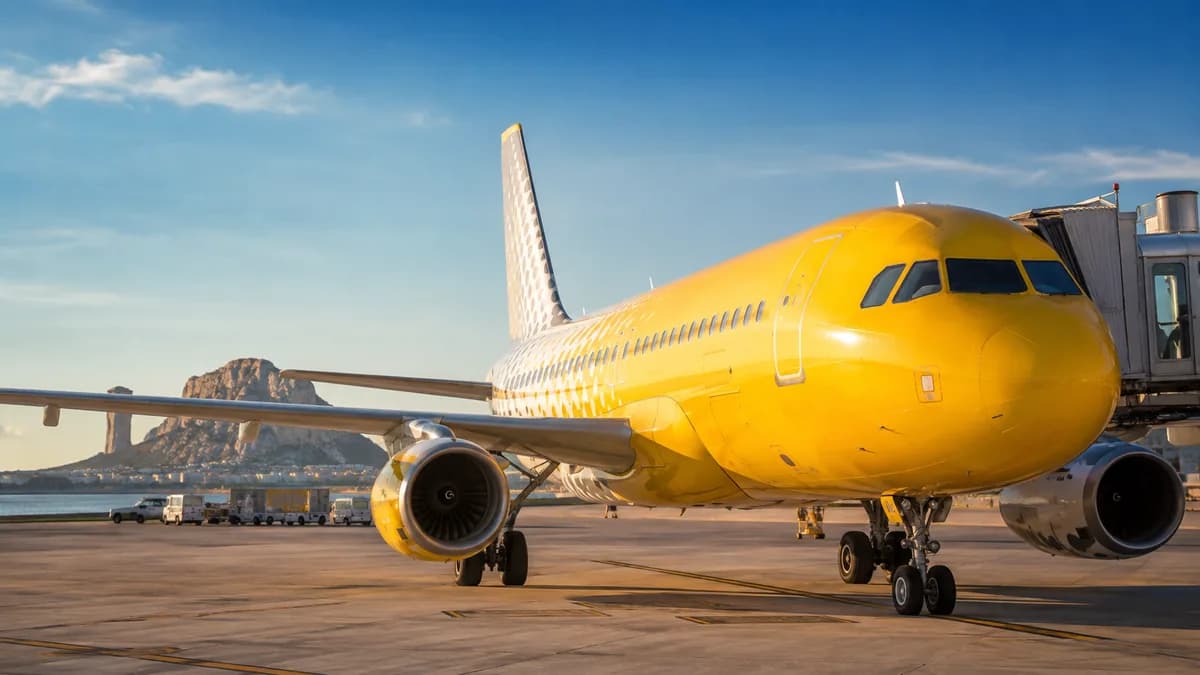 Yellow Vueling plane on the tarmac in front of the terminal, illustrating the Vueling tax refund process
